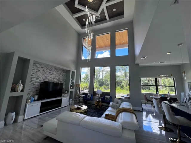 Living area featuring recessed lighting and a high ceiling