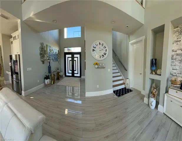 Entrance foyer featuring a high ceiling and stairs