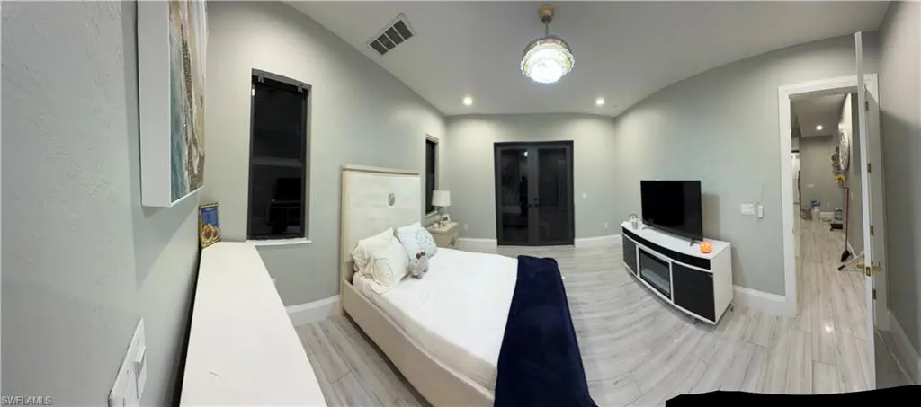 Bedroom featuring wood tiled floors and baseboards
