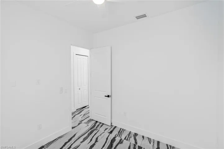 Spare room with baseboards and ceiling fan