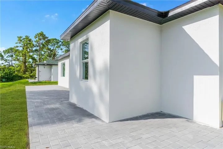 View of home's exterior featuring stucco siding and a yard
