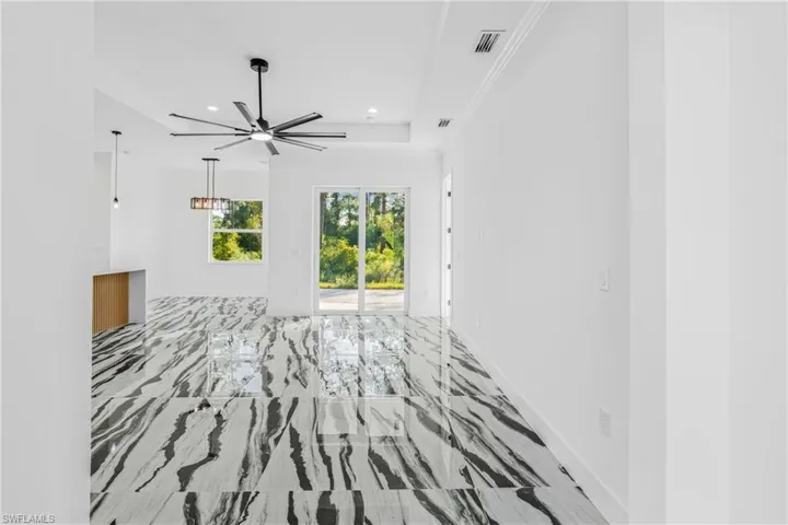 Spare room featuring light marble finish flooring, recessed lighting, ceiling fan, and crown molding