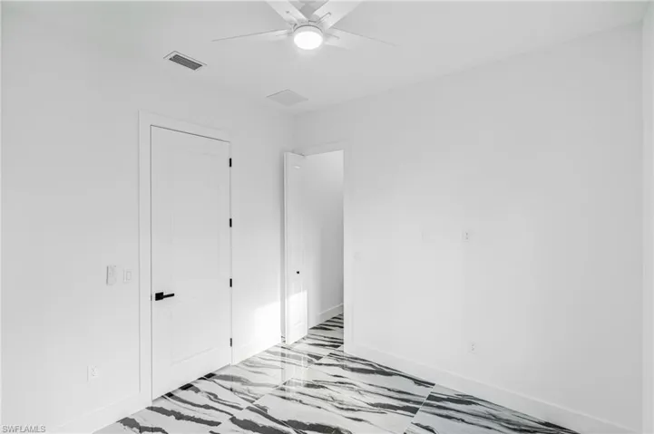 Unfurnished bedroom with baseboards and a ceiling fan