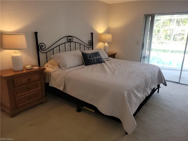 Carpeted bedroom with access to exterior