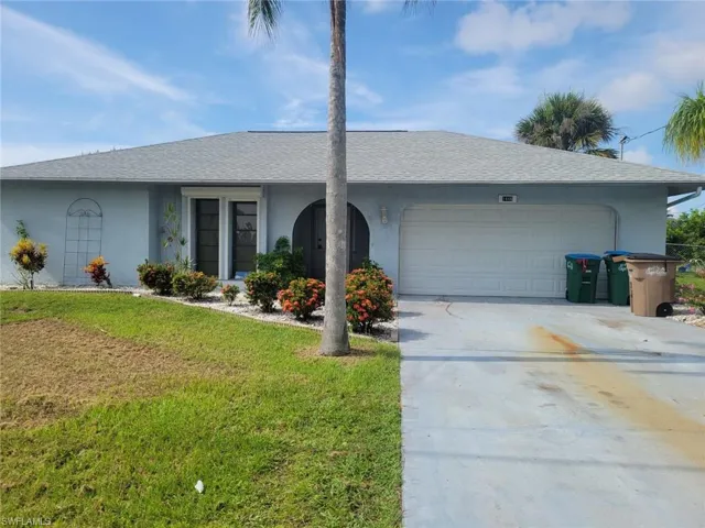 Ranch-style home with a garage and a front yard