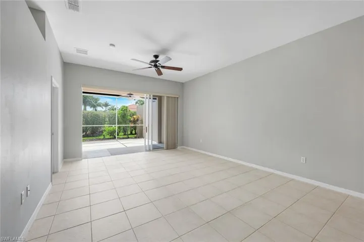 Unfurnished room featuring a ceiling fan, baseboards, and light tile patterned floors