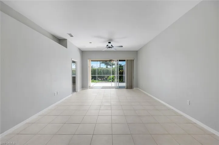 Spare room featuring a ceiling fan and baseboards