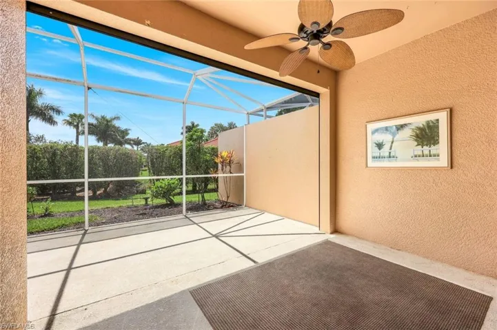 View of patio featuring ceiling fan and glass enclosure