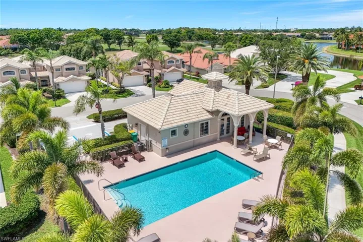 Community pool with a patio area, french doors, a residential view, and a water view