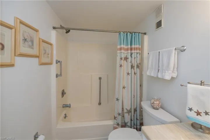 Charming guest bathroom conveniently located adjacent to the guest room and great room with a linen closet in the hallway.