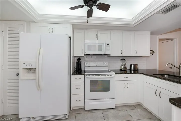 Well lit from above with a fan and adjacent pantry