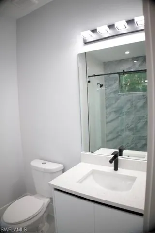 Bathroom with vanity and a stall shower