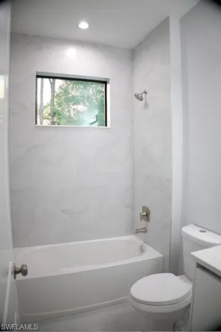 Bathroom featuring vanity and  shower combination