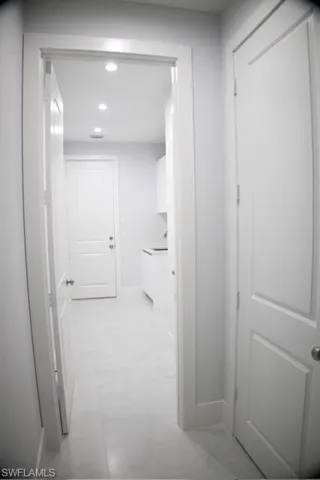 Hall featuring recessed lighting and baseboards