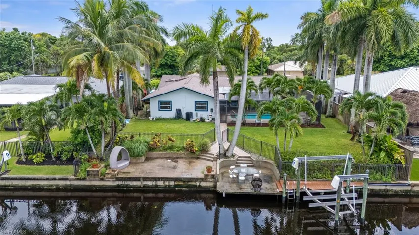 View of dock featuring a water view and a lawn