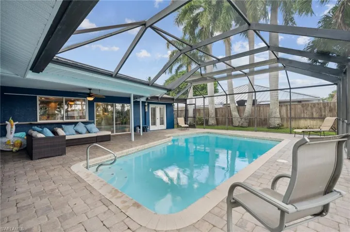 View of swimming pool with an outdoor living space, a lanai, a patio area, and ceiling fan