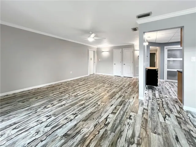 Great room featuring ornamental molding, hardwood / wood-style flooring, and ceiling fan