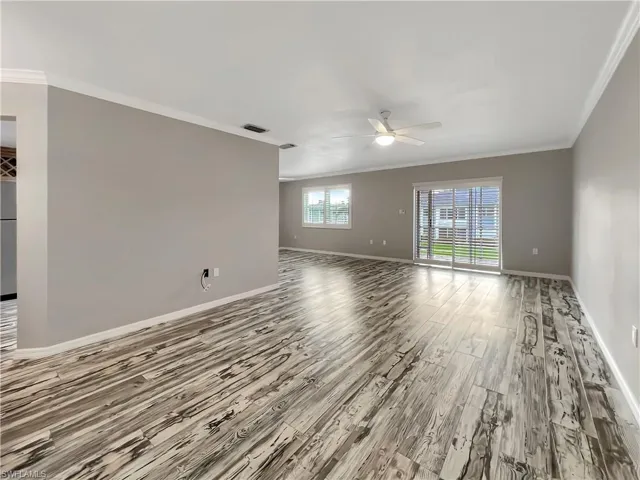 Great room featuring ornamental molding, hardwood / wood-style flooring, and ceiling fan