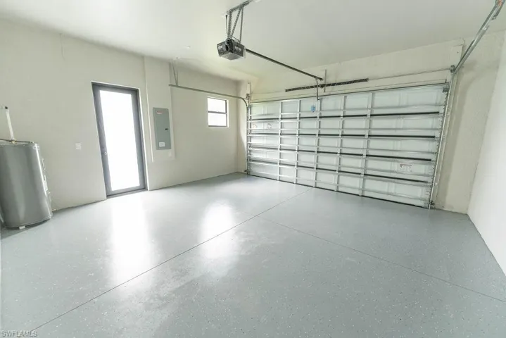 Garage with a garage door opener and electric panel