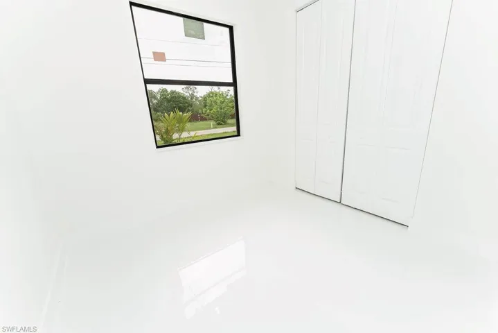Unfurnished bedroom with a closet and light tile patterned flooring