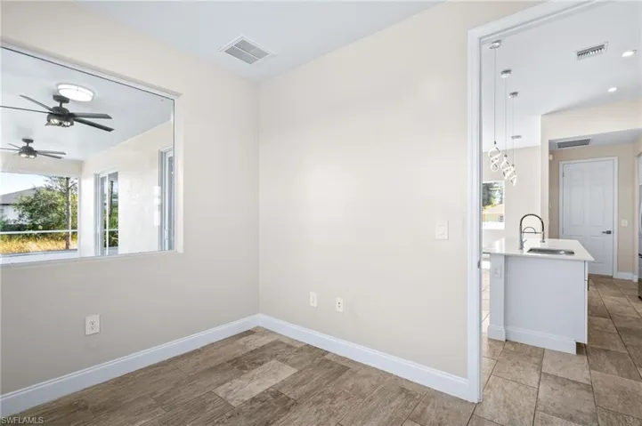 Spare room featuring ceiling fan and light wood-type flooring