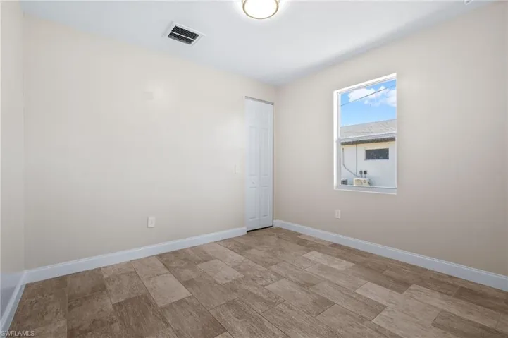 Unfurnished room with baseboards