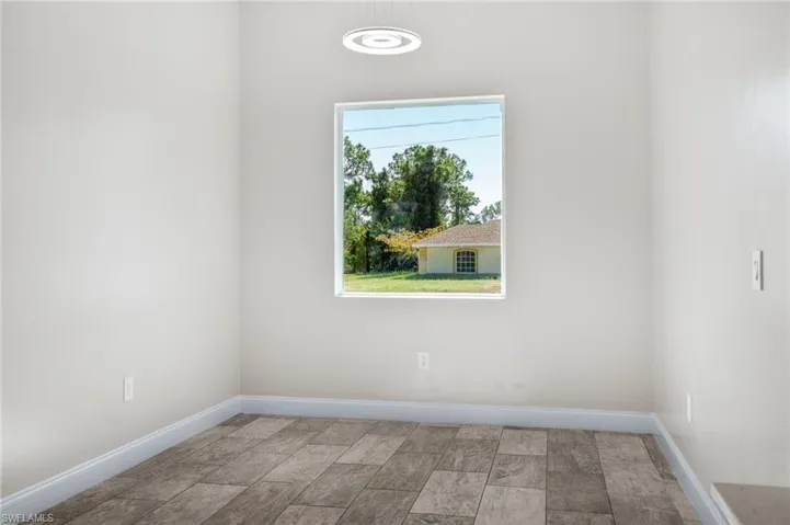 Unfurnished room with baseboards