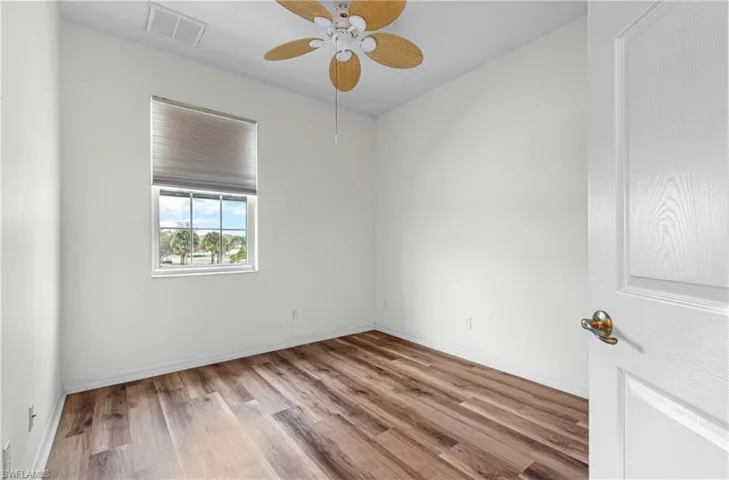 Unfurnished room featuring wood finished floors and ceiling fan