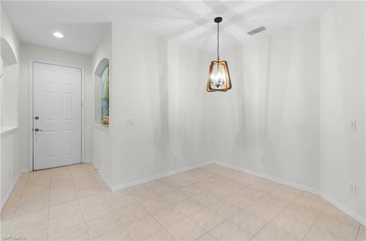 Unfurnished dining area featuring a chandelier, recessed lighting, and light tile patterned floors