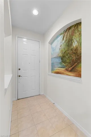 Foyer entrance featuring light tile patterned flooring and recessed lighting