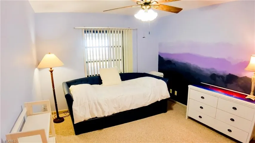 Bedroom featuring light colored carpet and ceiling fan