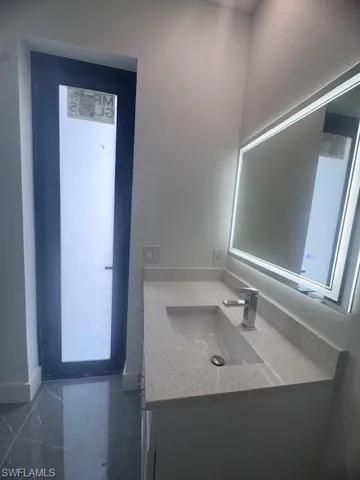 Bathroom with vanity and baseboards