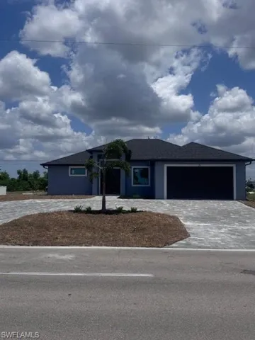 Prairie-style home featuring decorative driveway and an attached garage