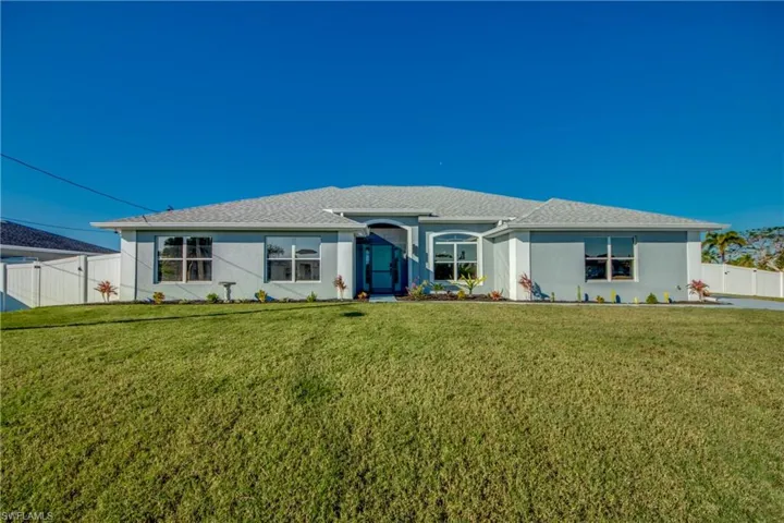 Single story home featuring a front lawn
