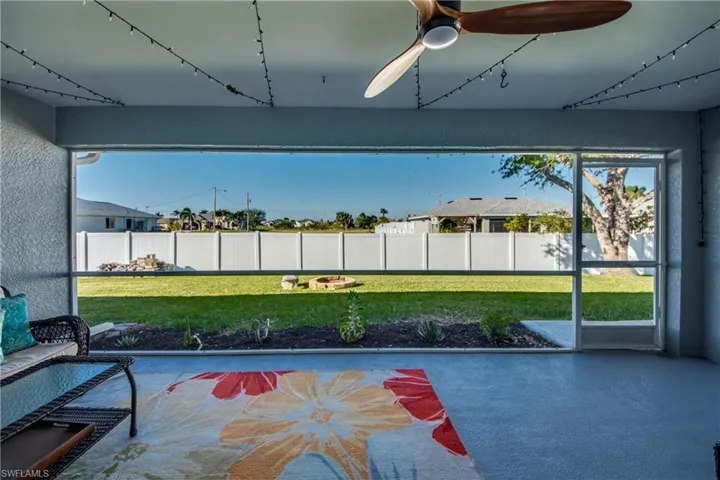 Unfurnished sunroom featuring ceiling fan
