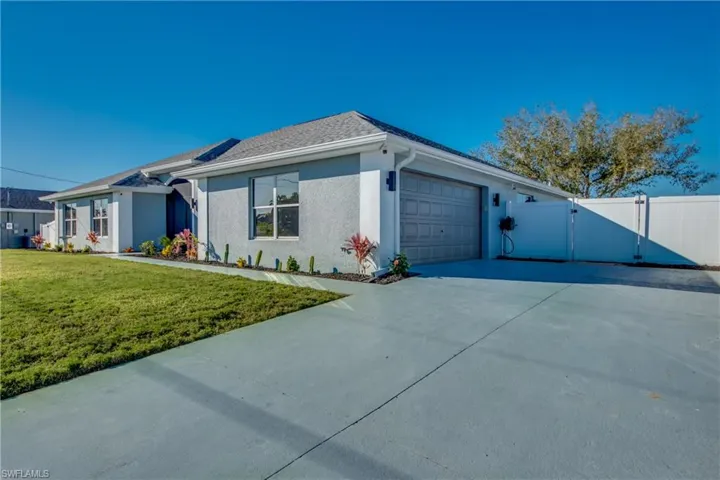 View of front of house with a front yard and a garage