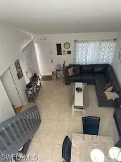 Living room with light tile patterned flooring