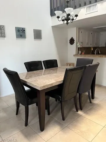 Tiled dining area with an inviting chandelier