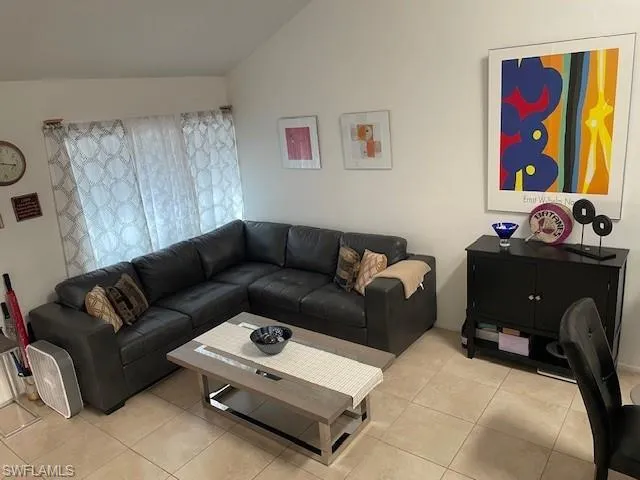 Tiled living room with vaulted ceiling