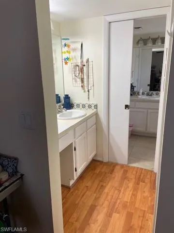 Bathroom featuring hardwood / wood-style flooring and vanity