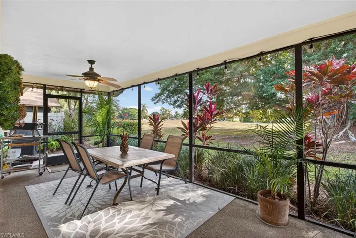 Sunroom with carpet flooring and floor to ceiling windows