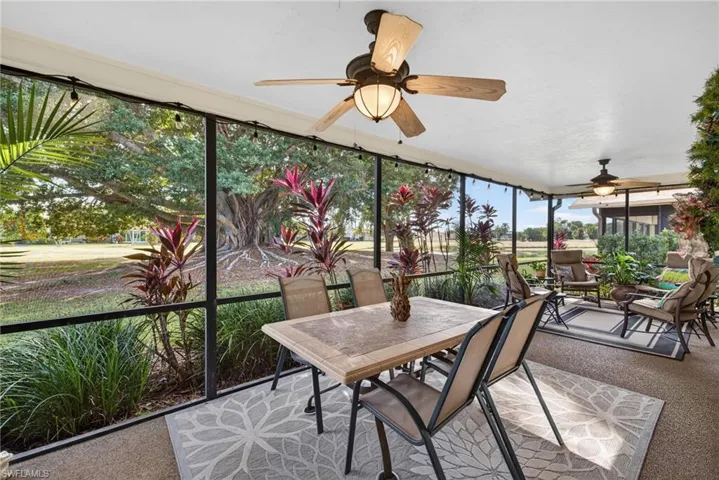 Sunroom with carpet floors and expansive windows