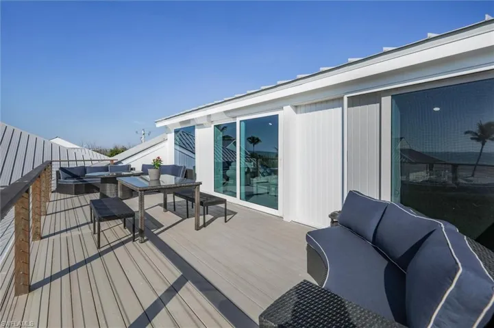 Wooden deck with outdoor dining space and an outdoor living space