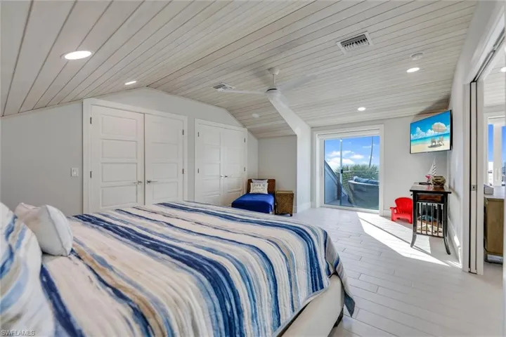 Bedroom featuring access to outside, lofted ceiling, recessed lighting, wooden ceiling, and wood finished floors