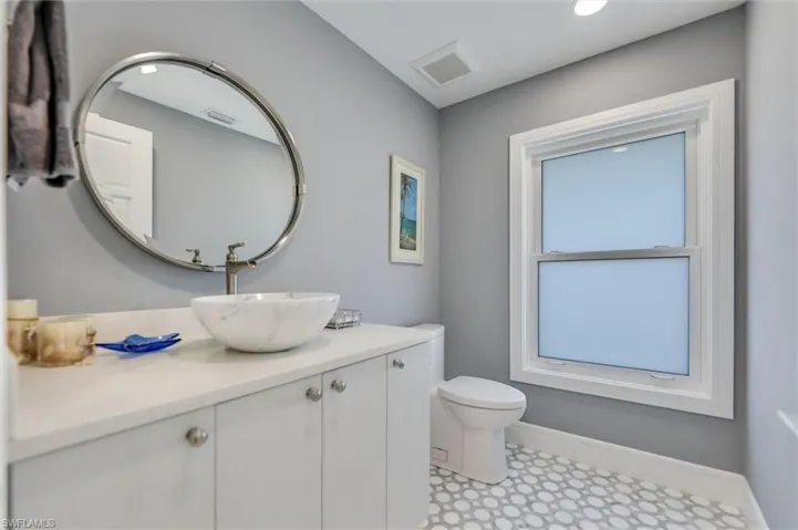 Half bathroom featuring vanity and toilet