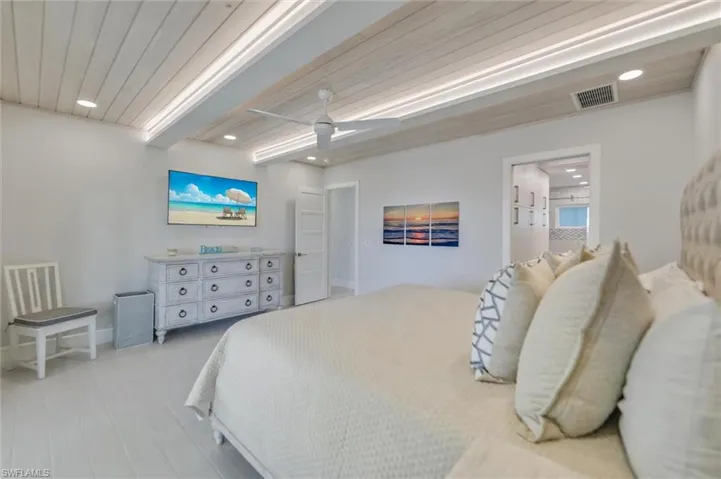 Bedroom with a wooden ceiling with exposed beams, recessed lighting, light wood-type flooring, and a ceiling fan