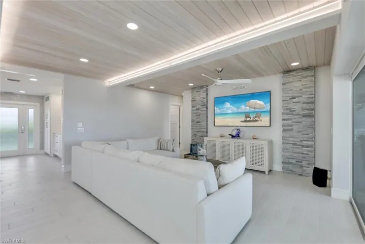 Living room featuring a wooden ceiling with exposed beams, a ceiling fan, light wood finished floors, and recessed lighting