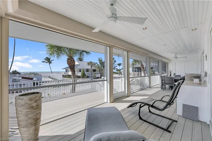 Sunroom featuring ceiling fan, wood finished floors, a wooden deck, wooden ceiling, and recessed lighting