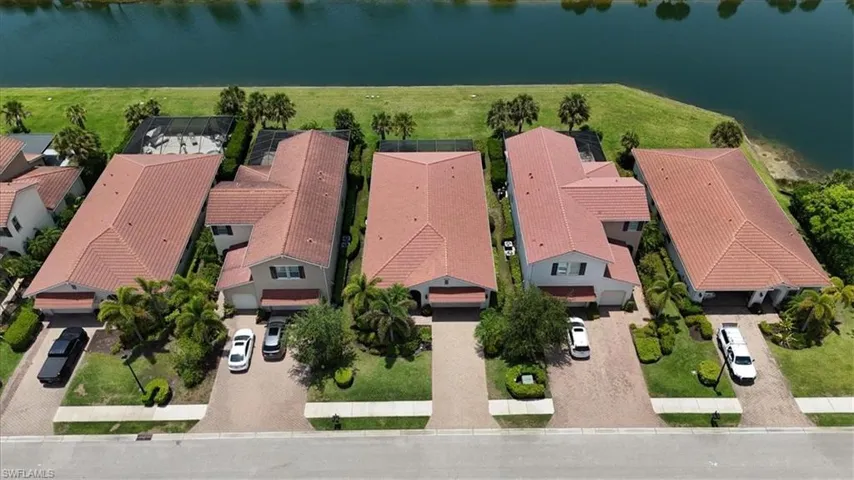 Aerial view of residential area featuring a nearby body of water