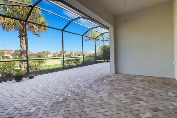 View of patio with a lanai and a lake view